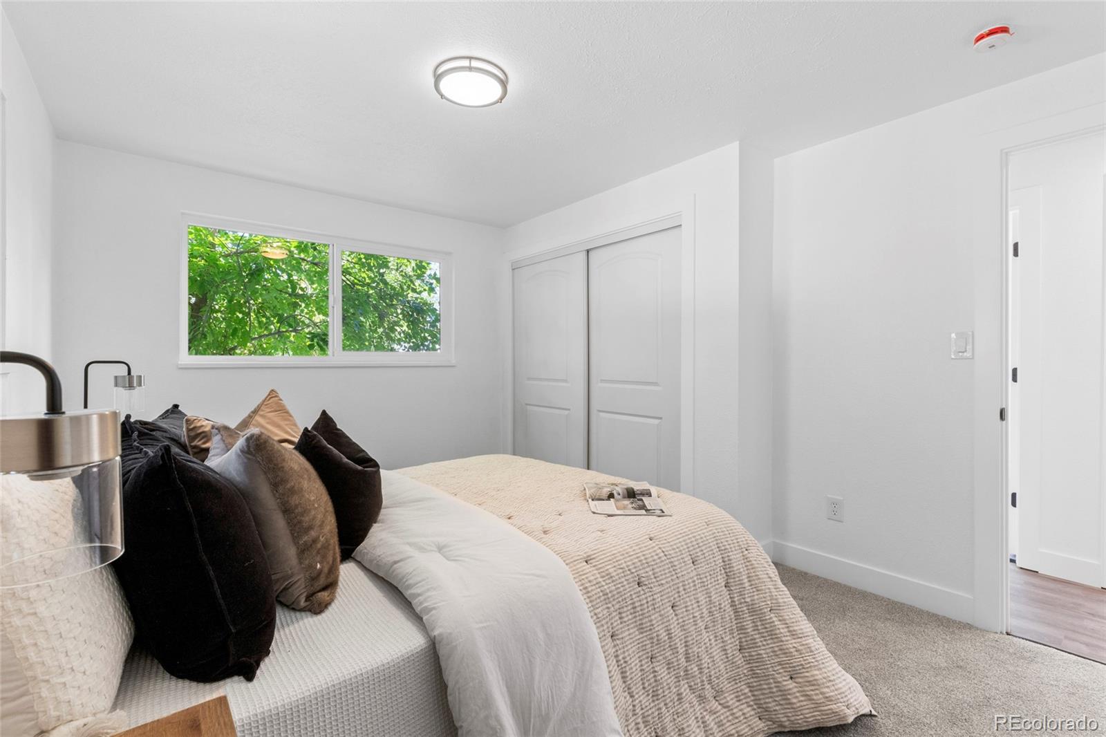 700 Busch Street Longmont, CO 80501 - Photo 14 of 27 a bedroom with a bed and a window