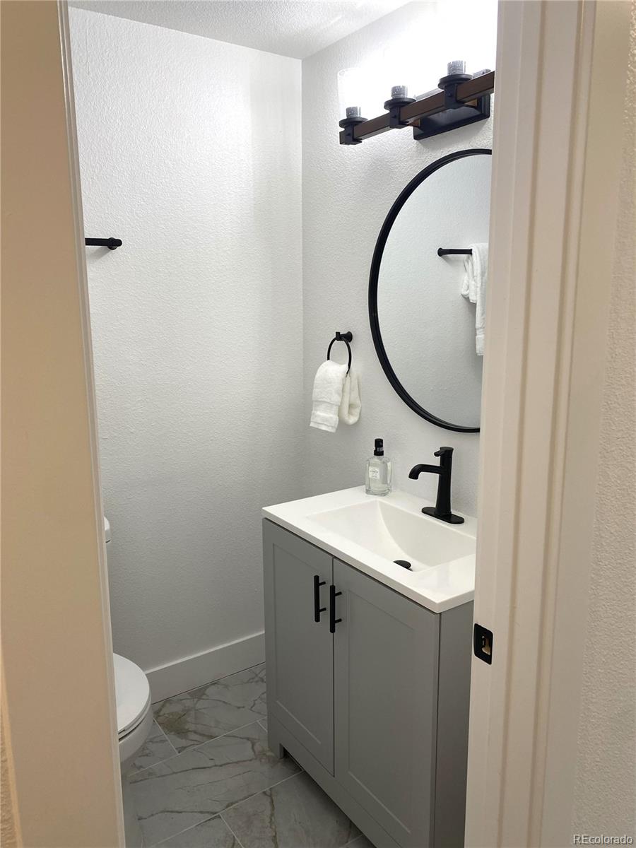 700 Busch Street Longmont, CO 80501 - Photo 16 of 27 a bathroom with a sink and mirror