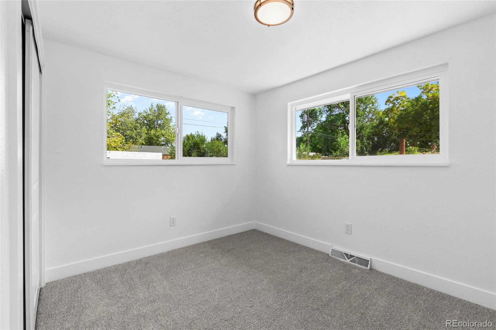 700 Busch Street Longmont, CO 80501 - Photo 18 of 27 an empty room with windows
