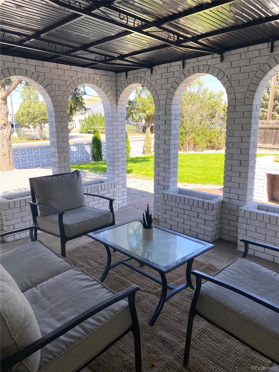 700 Busch Street Longmont, CO 80501 - Photo 22 of 27 a outdoor living space with furniture and a chandelier