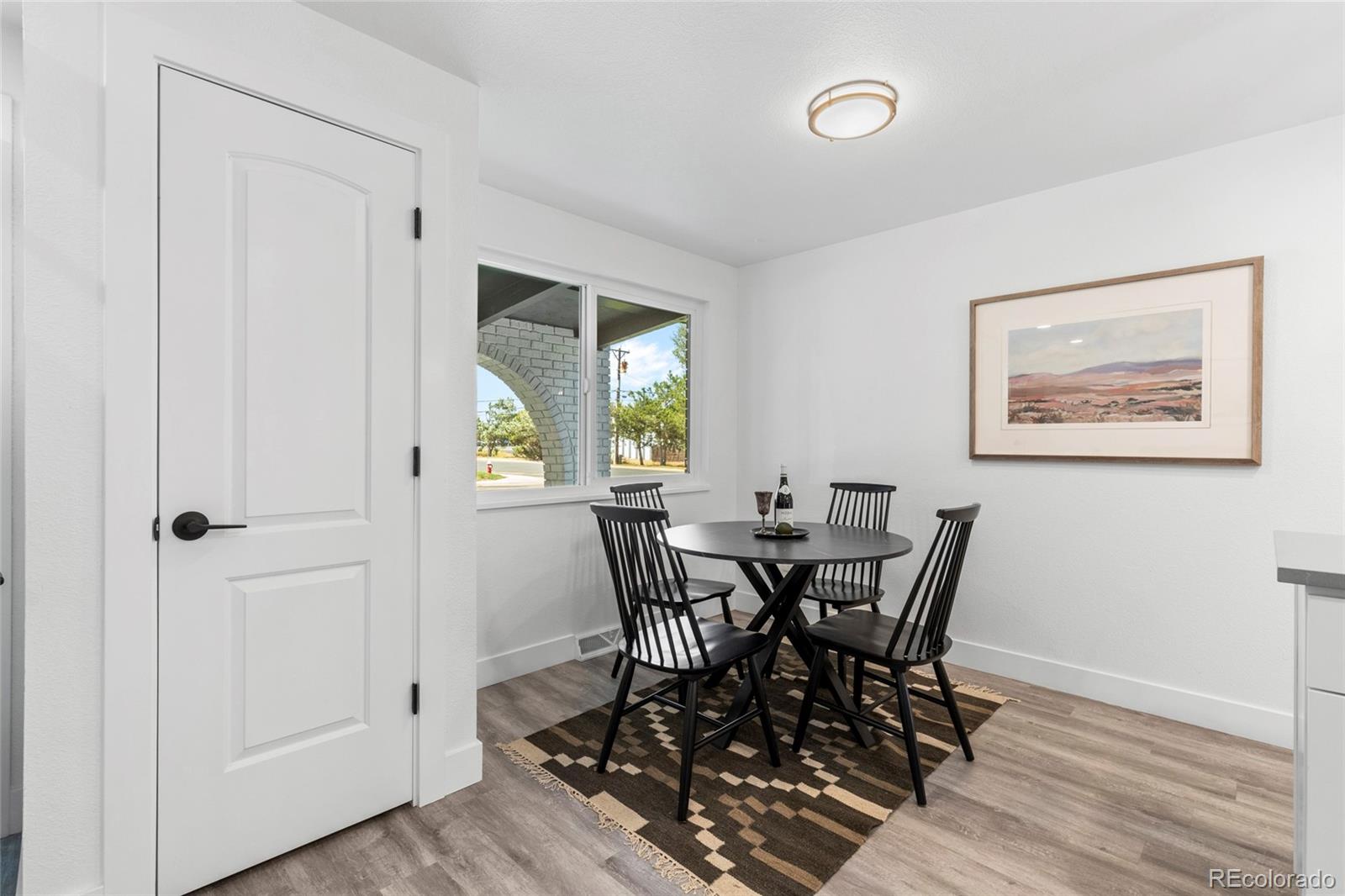700 Busch Street Longmont, CO 80501 - Photo 6 of 27 a view of a dining room with furniture and wooden floor