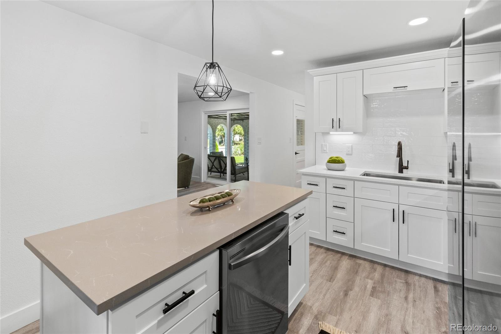 700 Busch Street Longmont, CO 80501 - Photo 9 of 27 a kitchen with cabinets stainless steel appliances and wooden floor