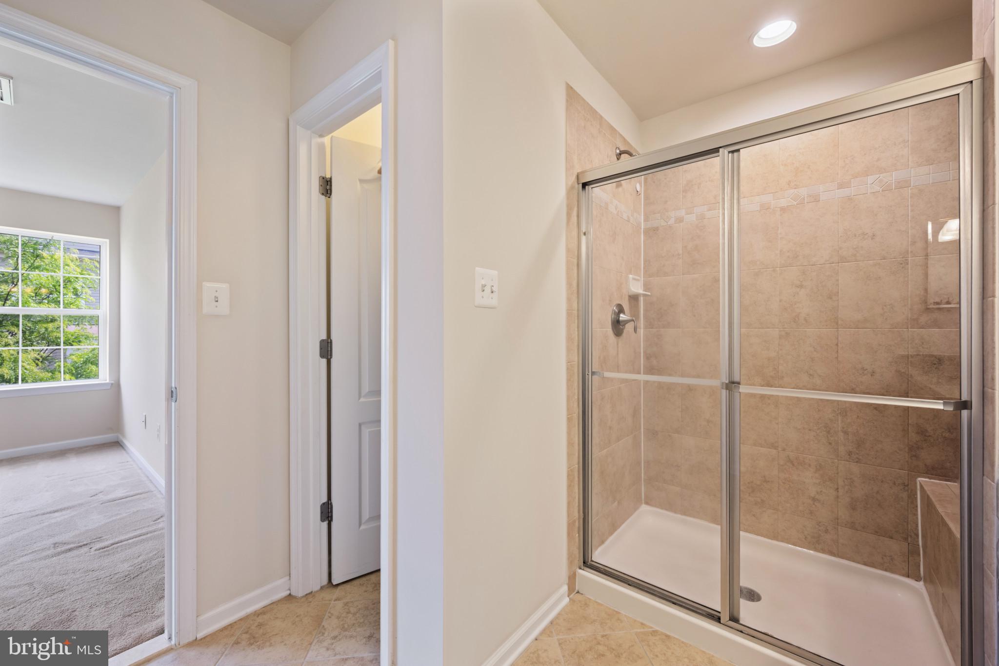 7062 Foxton Way Hanover, MD 21076 - Photo 26 of 41 a bathroom with a glass shower door