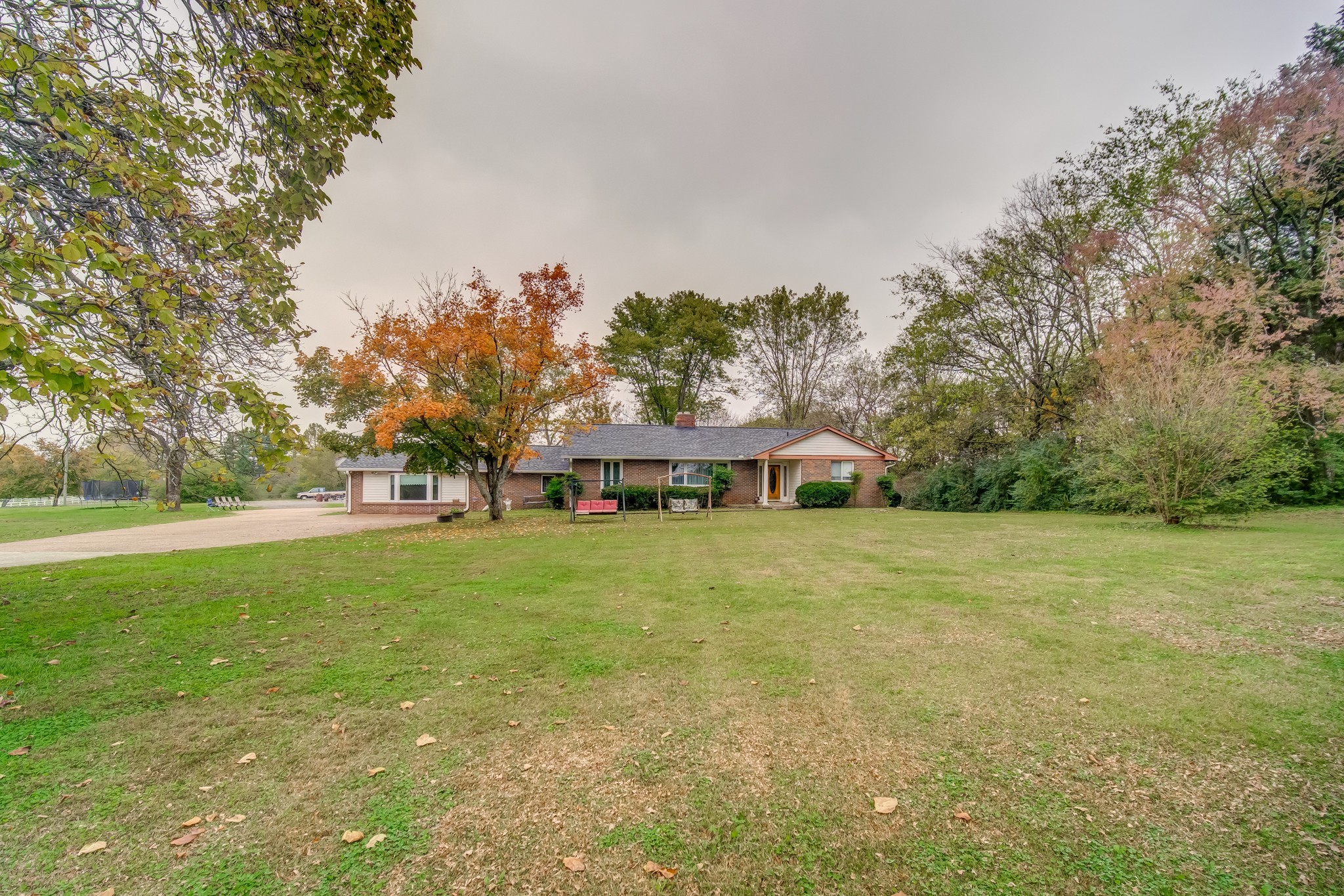 4302 Arno Road Franklin, TN 37064 - Photo 3 of 49 a front view of a house with a garden and trees