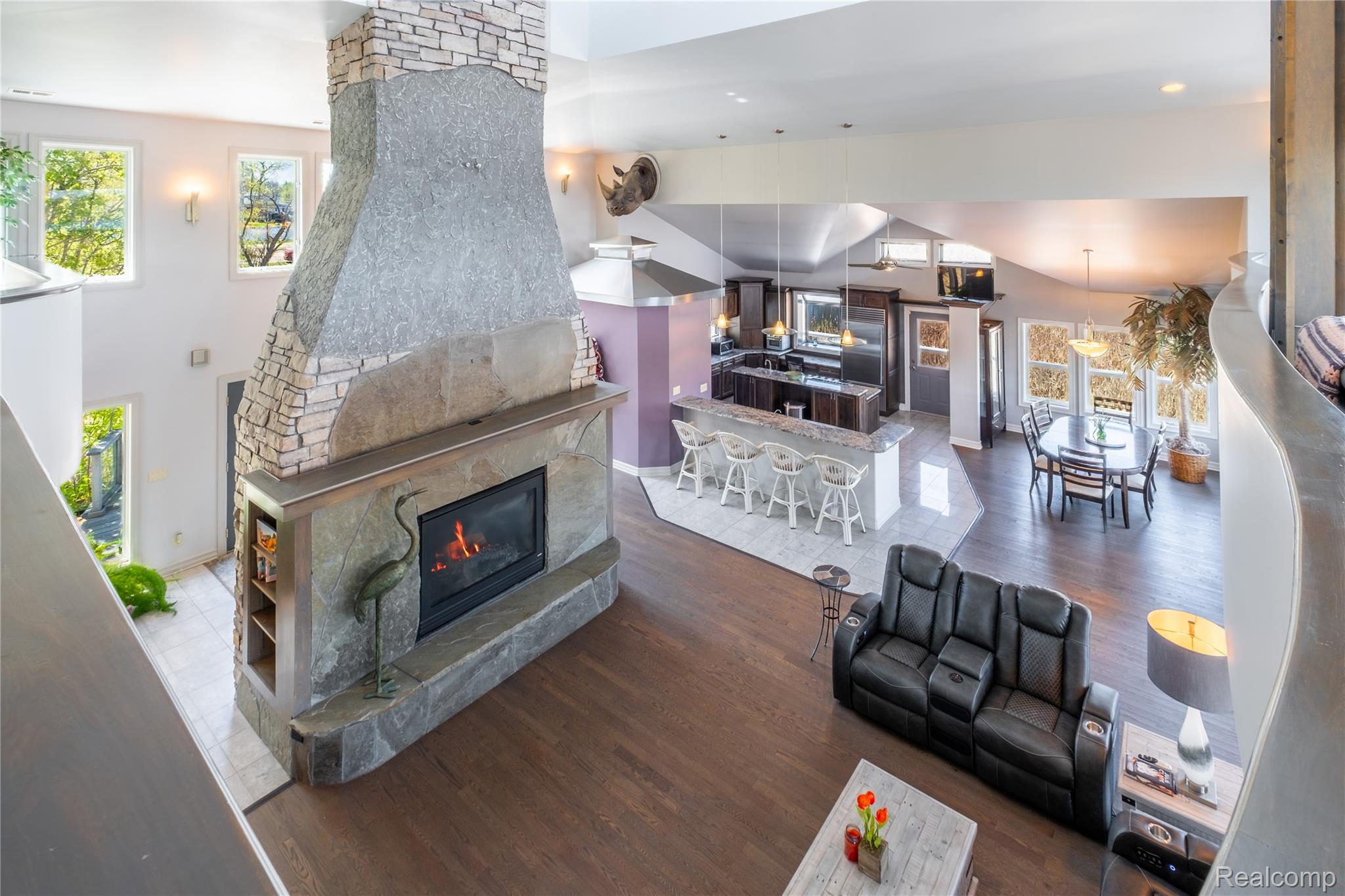 2350 Crane Road Fenton, MI 48430 - Photo 19 of 58 Living room with dark wood-type flooring, a large fireplace, recessed lighting, and a high ceiling