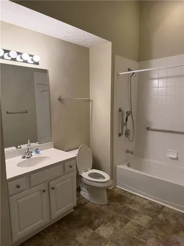 a bathroom with a double vanity sink toilet mirror and shower