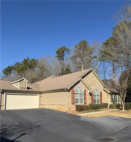 a view of a big house with large trees and plants