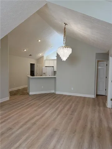 a view of a kitchen with a dishwasher cabinets and wooden floor