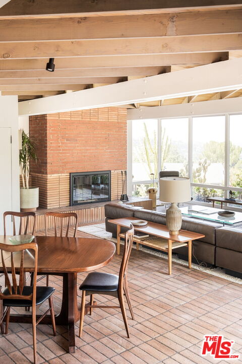 316 Redwood Drive Pasadena, CA 91105 - Photo 12 of 49 a living room with furniture a large window and wooden floor