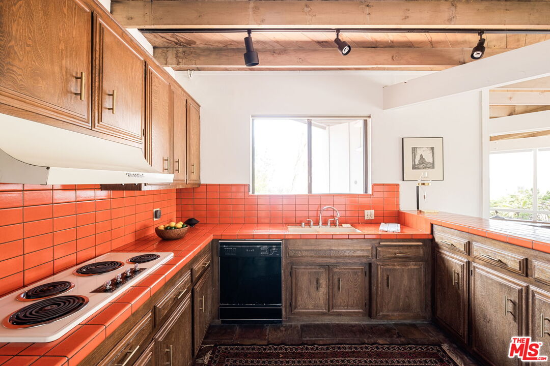 316 Redwood Drive Pasadena, CA 91105 - Photo 13 of 49 a kitchen with a sink stove and cabinets
