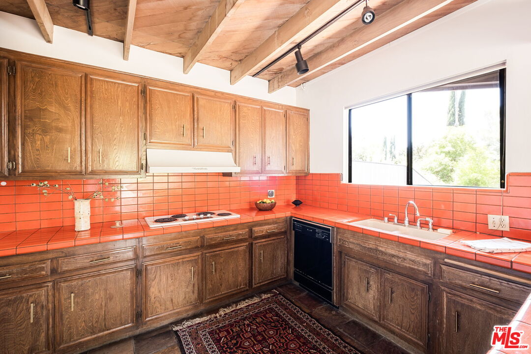 316 Redwood Drive Pasadena, CA 91105 - Photo 14 of 49 a kitchen with stainless steel appliances a sink a stove and cabinets