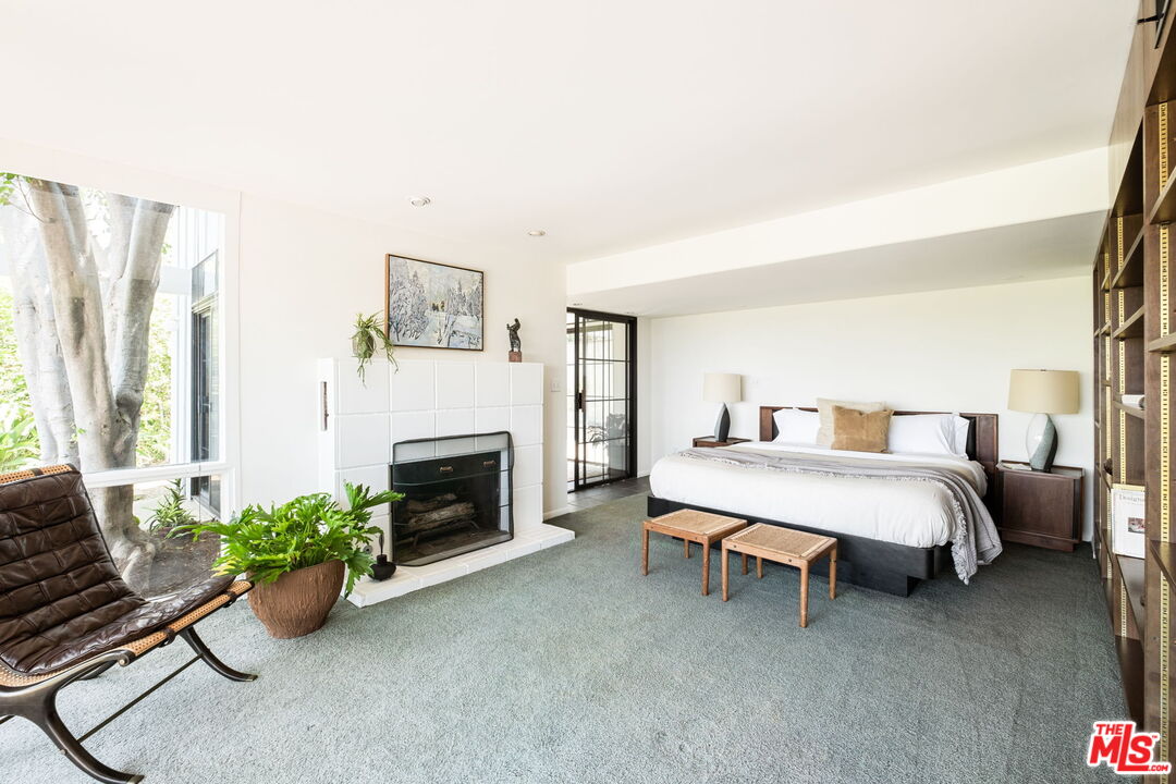 316 Redwood Drive Pasadena, CA 91105 - Photo 19 of 49 a spacious bedroom with a bed and a fireplace