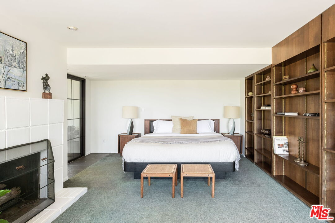 316 Redwood Drive Pasadena, CA 91105 - Photo 20 of 49 a bedroom with a bed and a fireplace