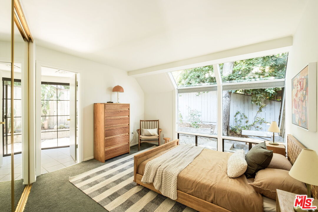 316 Redwood Drive Pasadena, CA 91105 - Photo 29 of 49 a bedroom with a bed and glass window