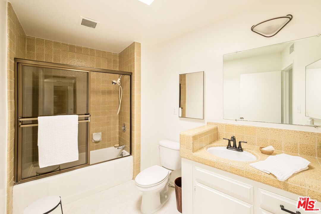 316 Redwood Drive Pasadena, CA 91105 - Photo 33 of 49 a bathroom with a sink and a mirror