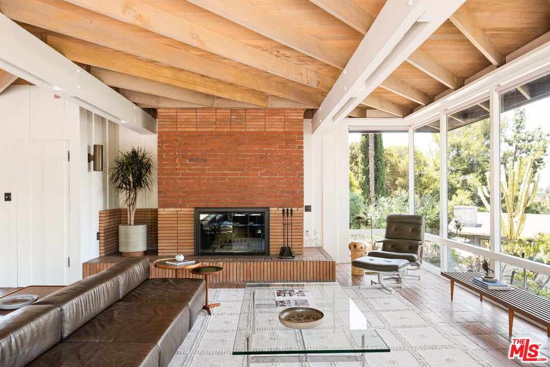 316 Redwood Drive Pasadena, CA 91105 - Photo 5 of 49 a living room with furniture a flat screen tv and a fireplace