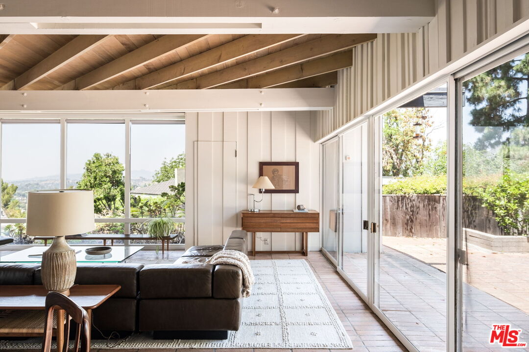 316 Redwood Drive Pasadena, CA 91105 - Photo 9 of 49 a living room with furniture and a floor to ceiling window