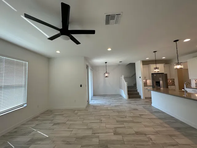 a large kitchen with kitchen island a sink stainless steel appliances and cabinets