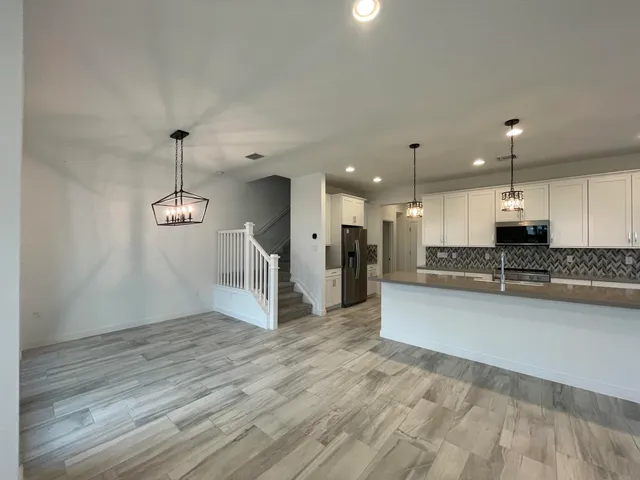 a view of a kitchen with a sink and cabinets
