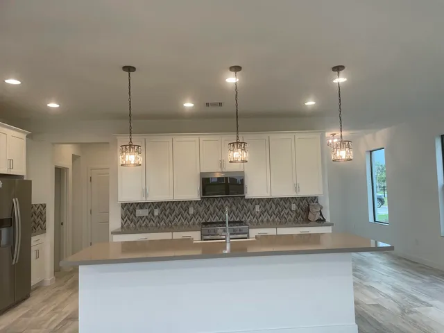 a kitchen with refrigerator and microwave