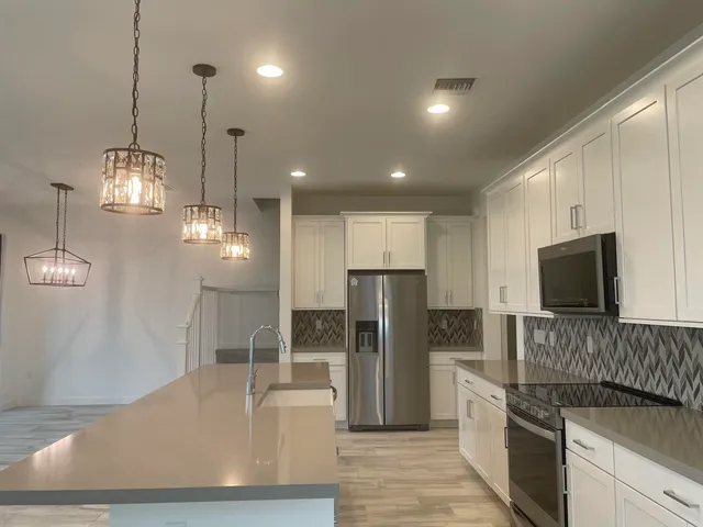 a view of a hallway with a chandelier