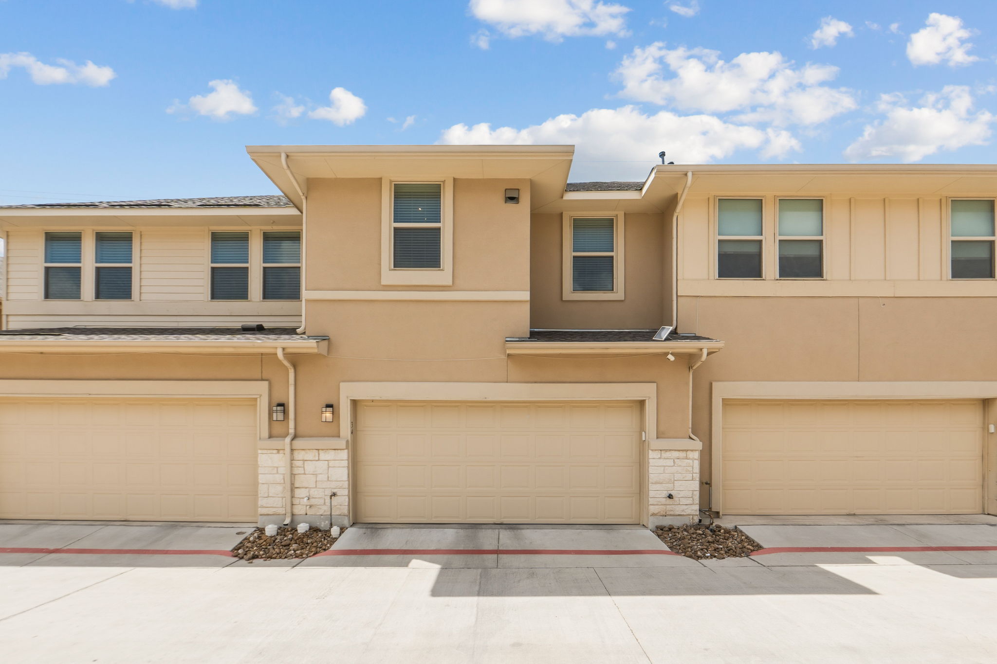 6814 East Riverside Drive, Unit 34 Austin, TX 78741 - Photo 26 of 26 a front view of a house with a yard and garage