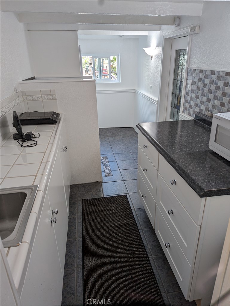 725 Box Canyon Road West Hills, CA 91304 - Photo 5 of 20 a kitchen with granite countertop a sink and a stove