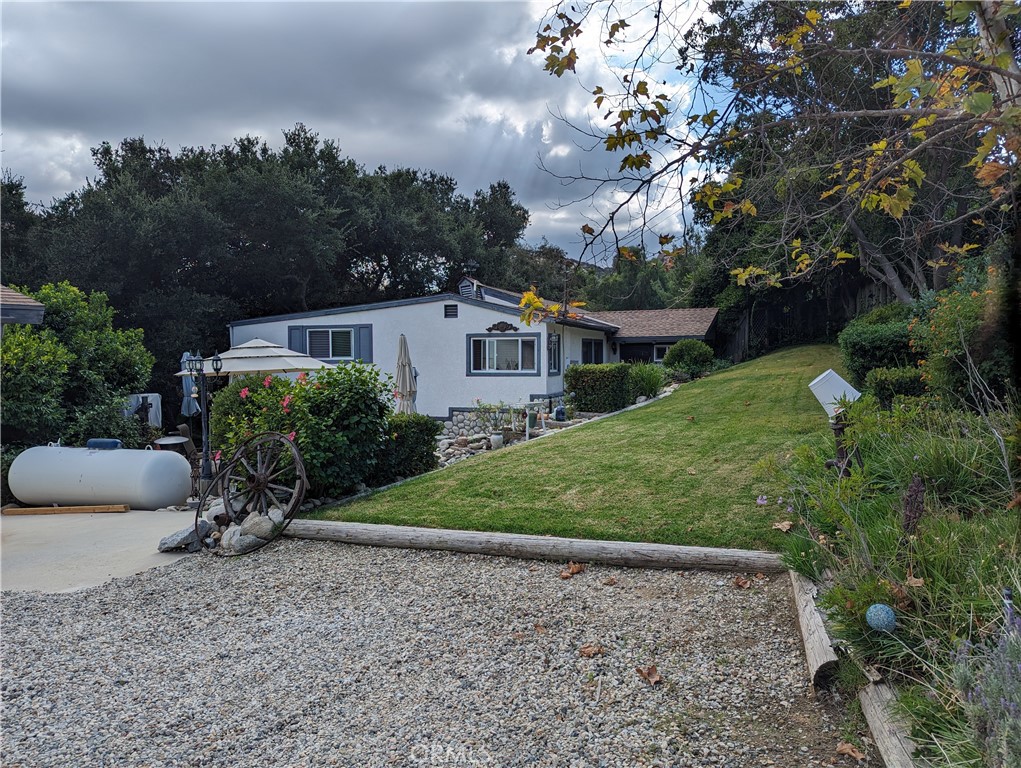 725 Box Canyon Road West Hills, CA 91304 - Photo 9 of 20 a view of a house with backyard and garden