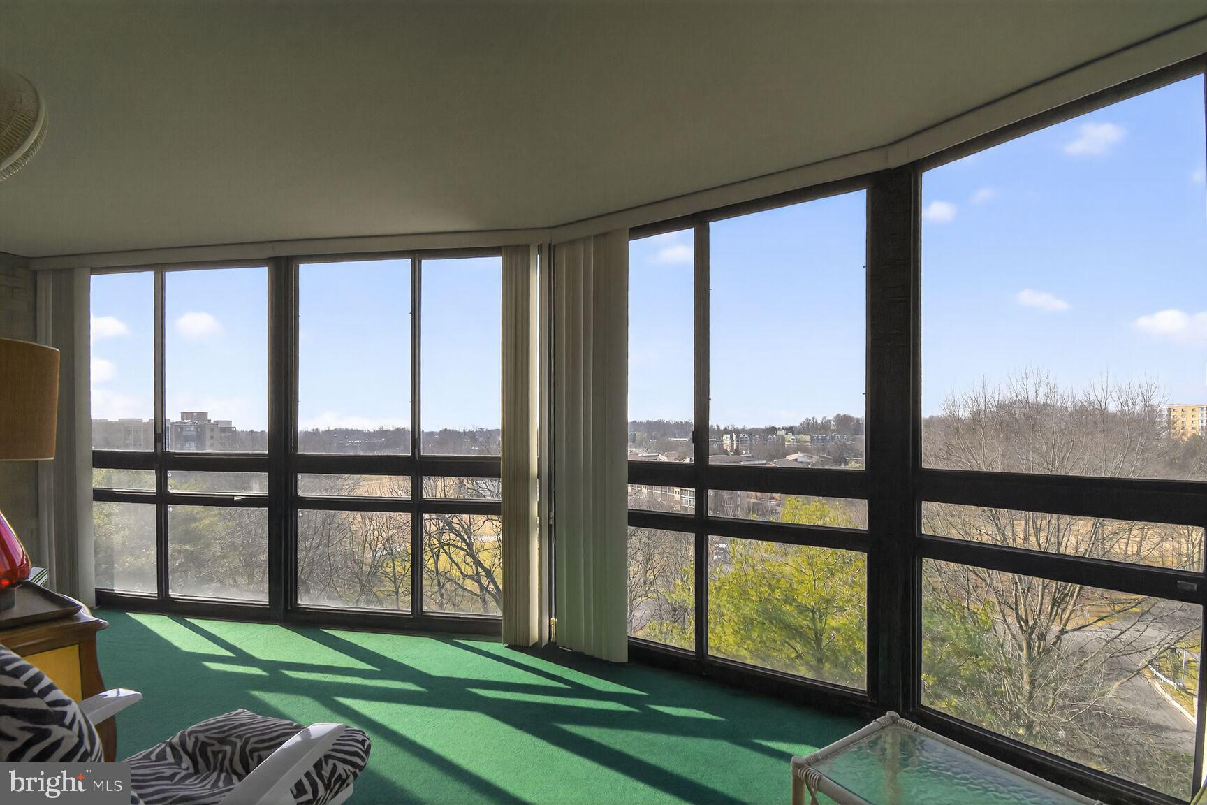 15115 Interlachen Drive, Unit 3904 Silver Spring, MD 20906 - Photo 11 of 43 a room with a large window and a bed