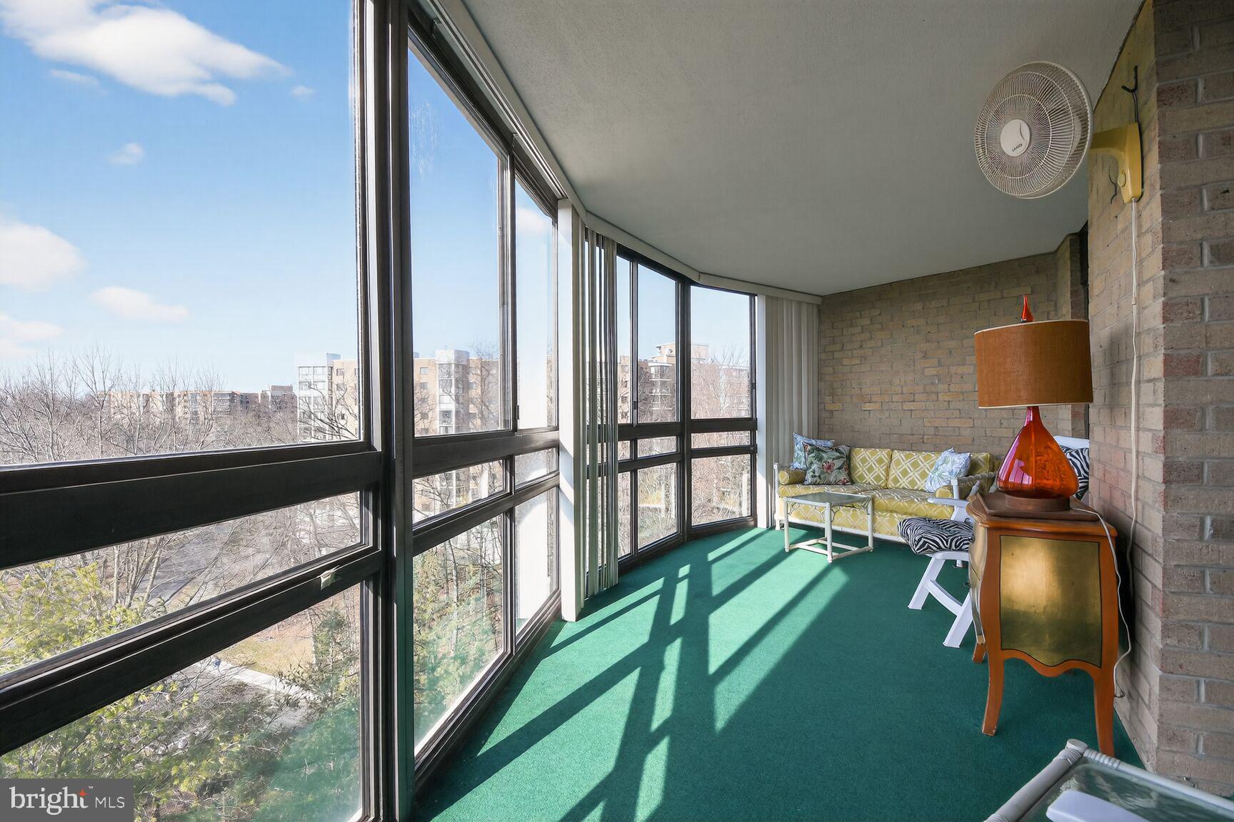 15115 Interlachen Drive, Unit 3904 Silver Spring, MD 20906 - Photo 13 of 43 a living room with furniture and a floor to ceiling window