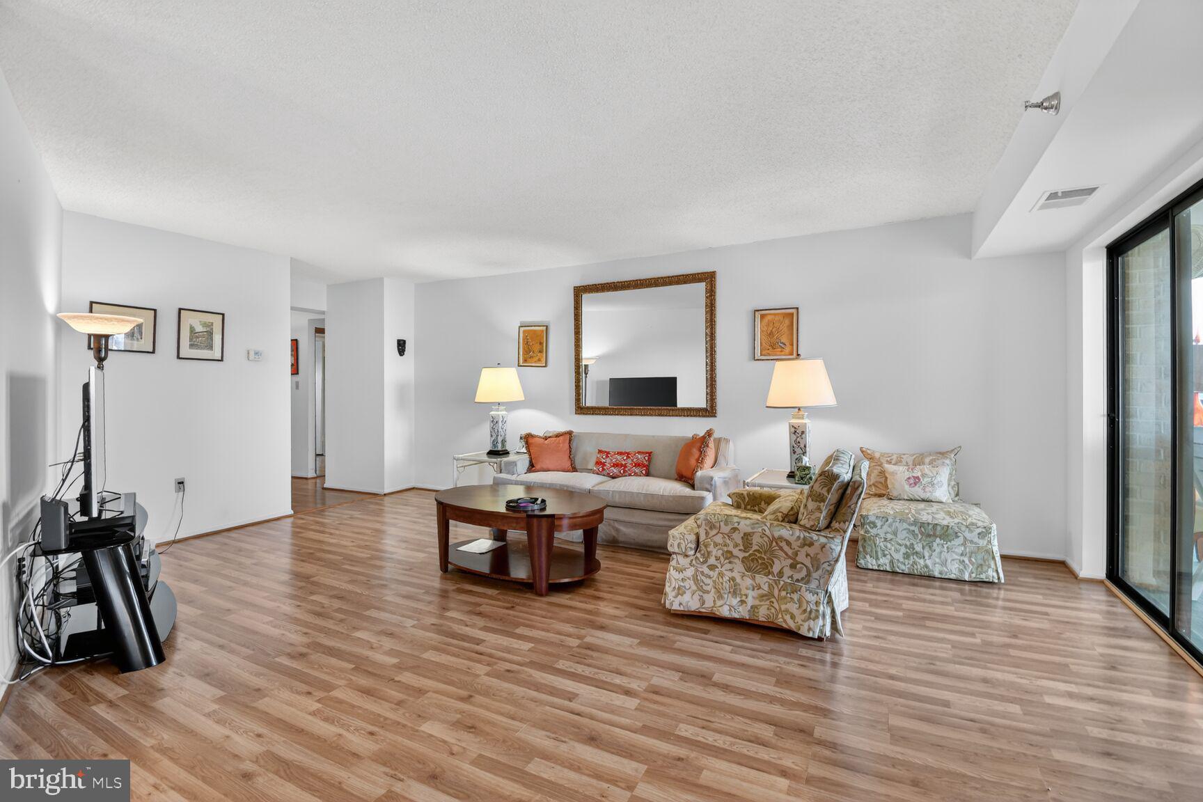 15115 Interlachen Drive, Unit 3904 Silver Spring, MD 20906 - Photo 14 of 43 a living room with furniture and a wooden floor