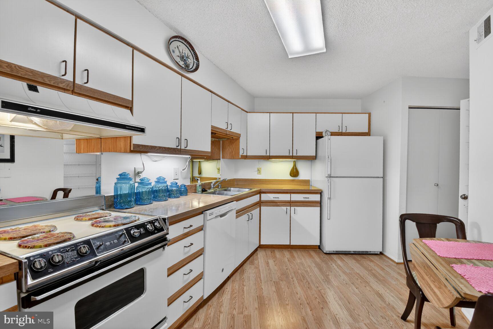 15115 Interlachen Drive, Unit 3904 Silver Spring, MD 20906 - Photo 16 of 43 a kitchen with stainless steel appliances granite countertop a stove a sink dishwasher and a refrigerator