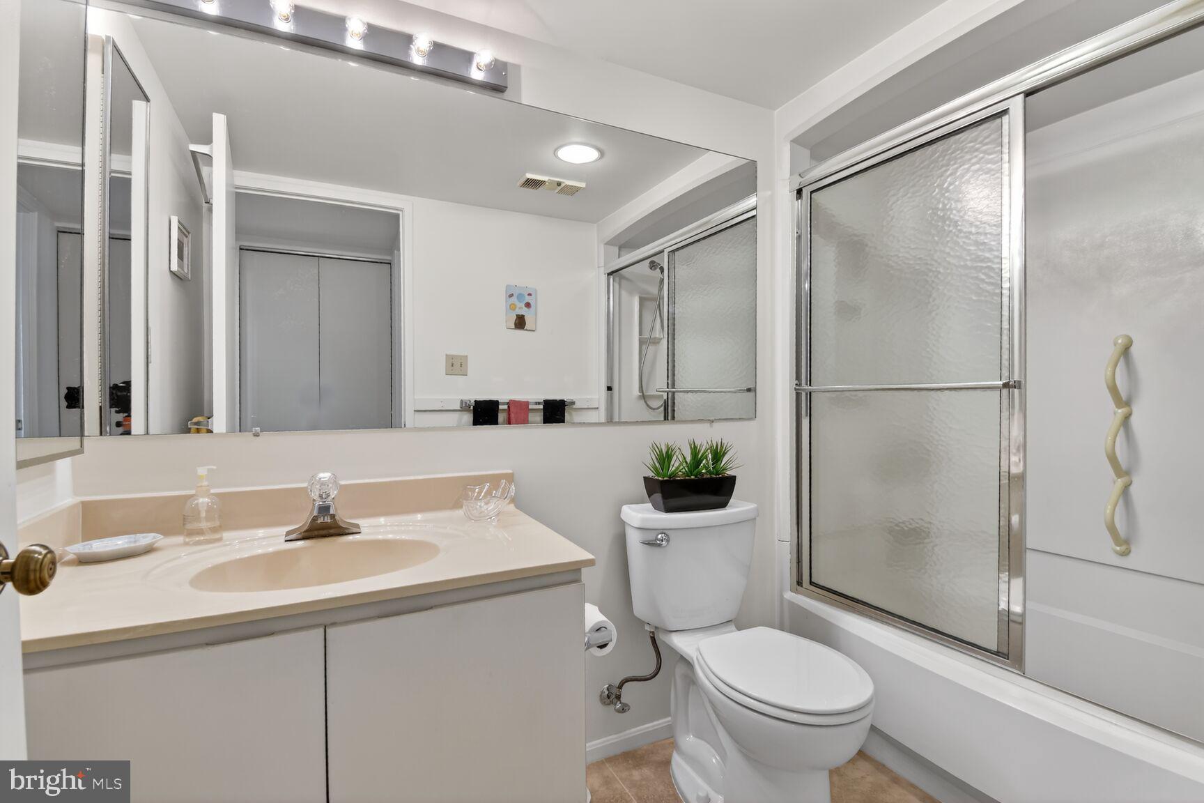 15115 Interlachen Drive, Unit 3904 Silver Spring, MD 20906 - Photo 20 of 43 a bathroom with a sink toilet and shower