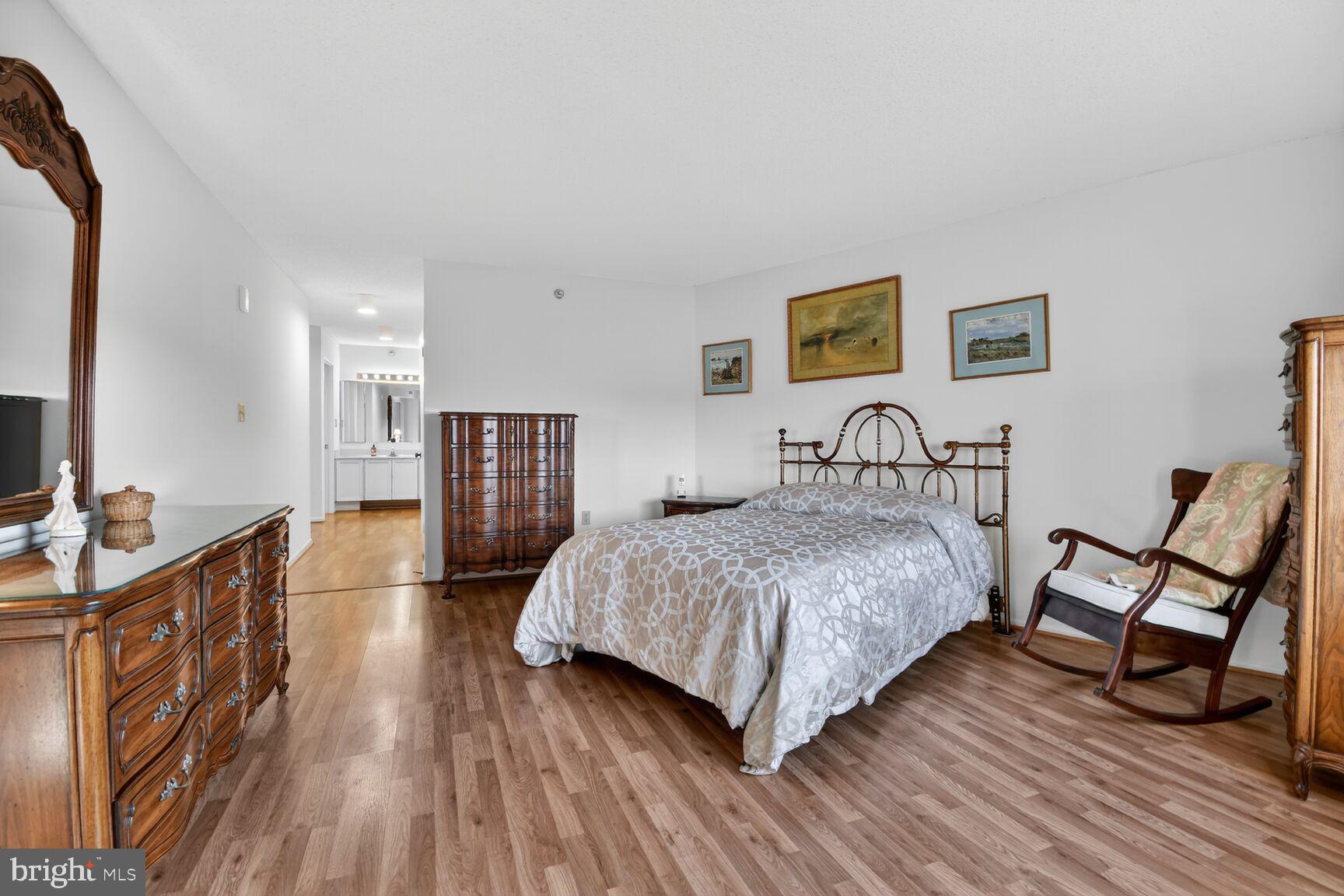 15115 Interlachen Drive, Unit 3904 Silver Spring, MD 20906 - Photo 22 of 43 a bedroom with a bed and wooden floor