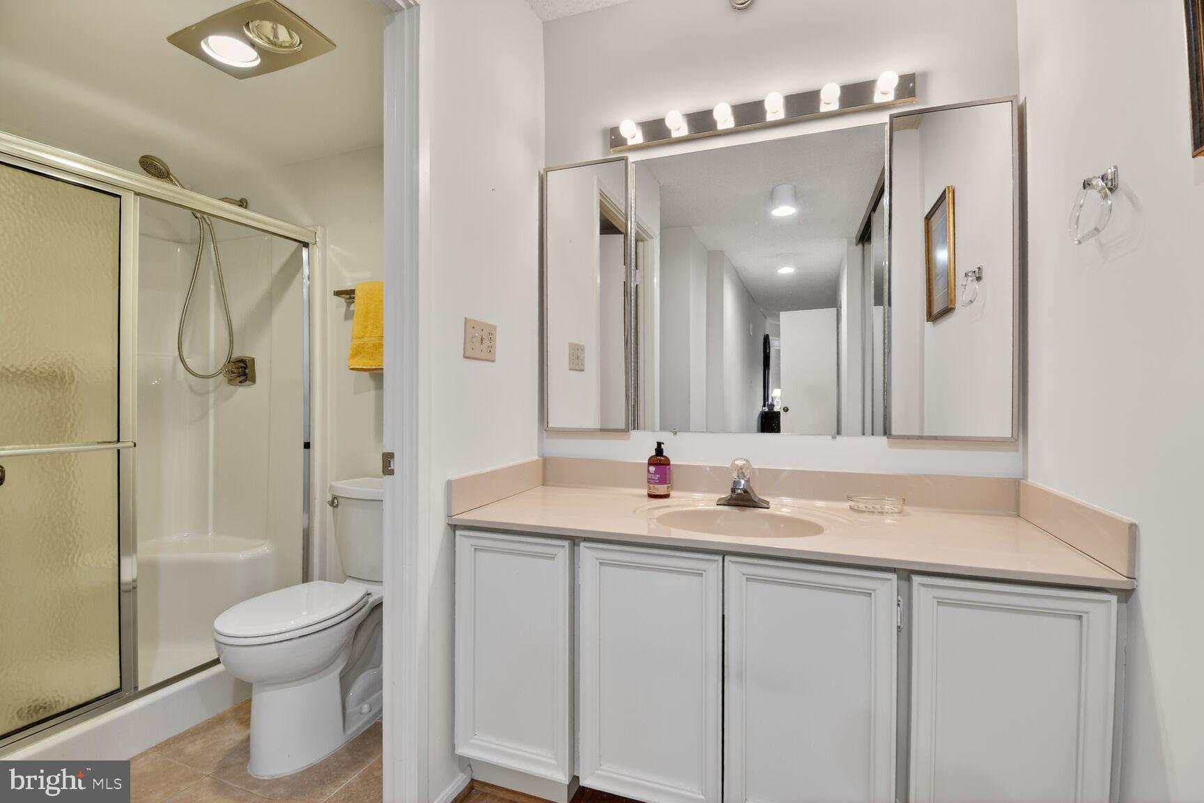 15115 Interlachen Drive, Unit 3904 Silver Spring, MD 20906 - Photo 23 of 43 a bathroom with a granite countertop sink a toilet and a mirror