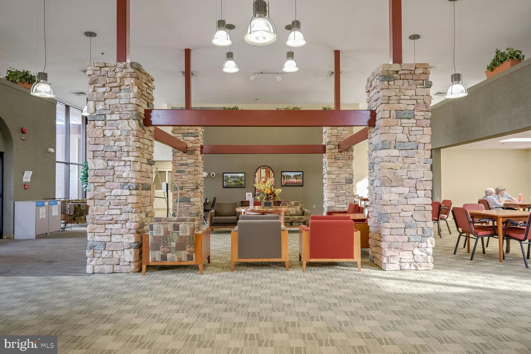 15115 Interlachen Drive, Unit 3904 Silver Spring, MD 20906 - Photo 32 of 43 a view of a dining room with furniture and chandelier