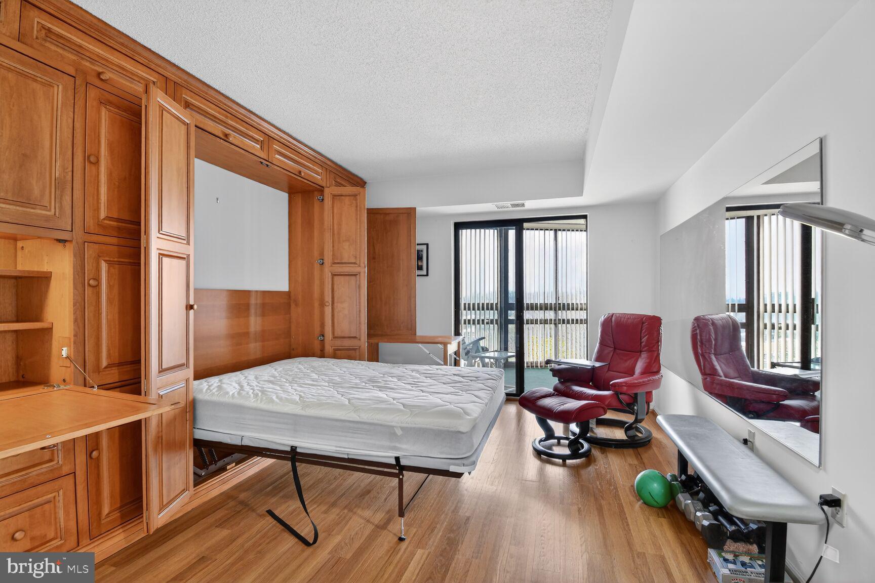 15115 Interlachen Drive, Unit 3904 Silver Spring, MD 20906 - Photo 7 of 43 a living room with furniture and a wooden floor