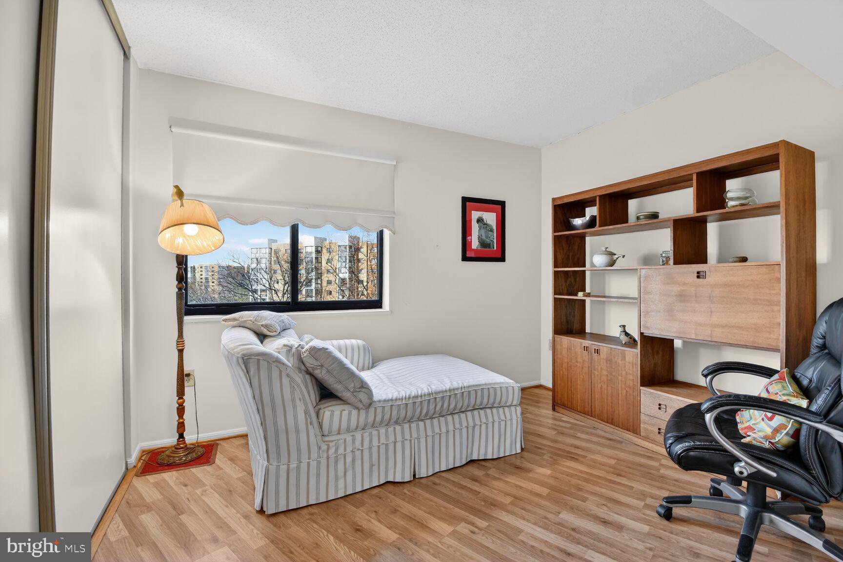 15115 Interlachen Drive, Unit 3904 Silver Spring, MD 20906 - Photo 9 of 43 a living room with furniture and a window