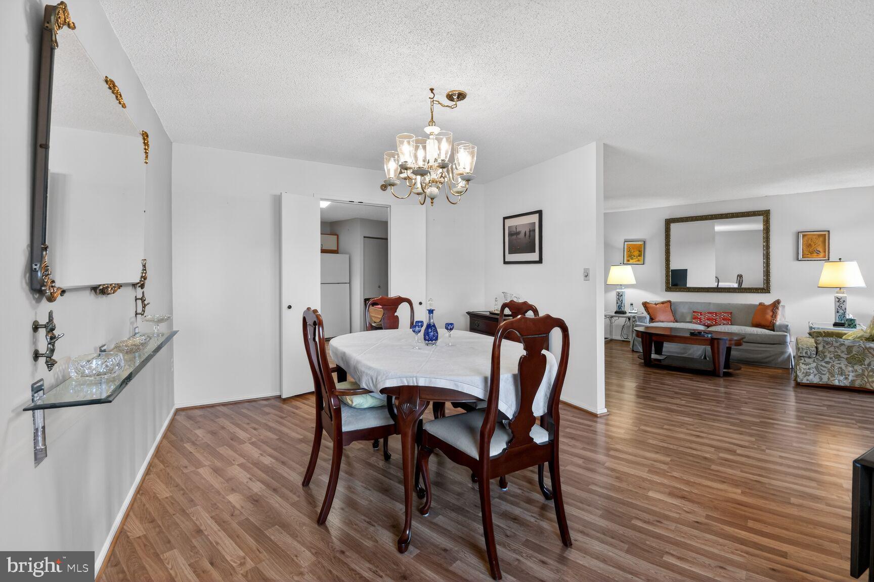 15115 Interlachen Drive, Unit 3904 Silver Spring, MD 20906 - Photo 9 of 43 a view of a dining room with furniture and wooden floor