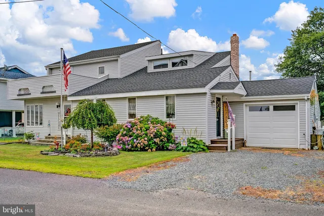 a front view of a house with a yard and outdoor seating