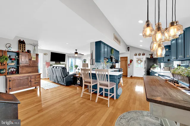 a living room with furniture a dining table and a fireplace