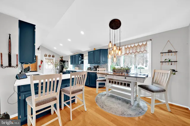 a living room with furniture a table and a large window