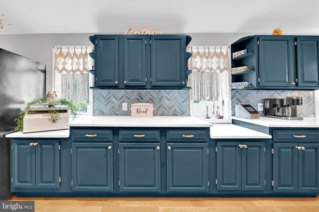 a kitchen with cabinets a sink and a stove