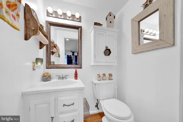 a white toilet sitting next to a bathroom sink