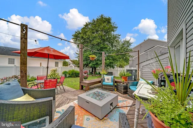 an outdoor sitting area with a table and chairs