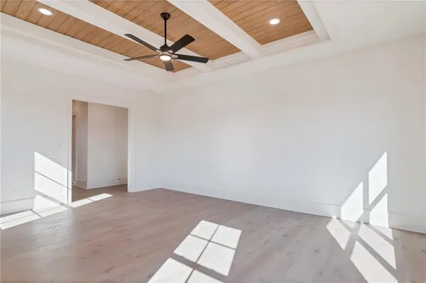 a view of an empty room with wooden floor