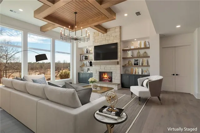 a view of a livingroom with furniture wooden floor and chandelier
