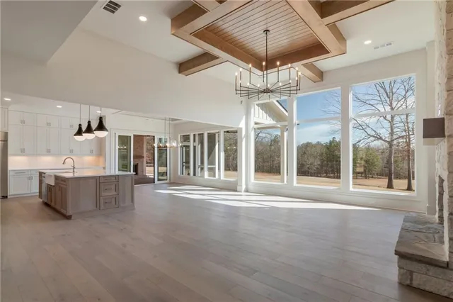 a kitchen with stainless steel appliances granite countertop white cabinets and a stove