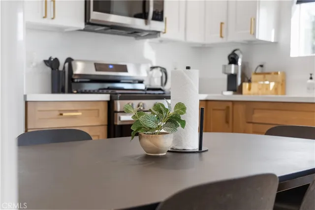 a kitchen with a stove and a white cabinets
