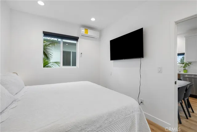 a bedroom with a bed and a flat screen tv